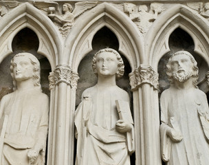 Fototapeta premium Statue. Entrance of the XIII century church. France.