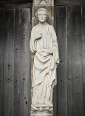Man of a God. Entrance of the XIII century church. France.