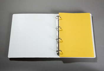 weißer DIN A4 Ordner mit gelbem Deckblatt