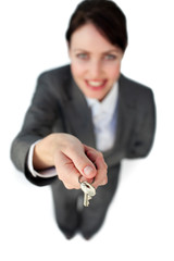 Smiling businesswoman holding a key