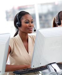 Serious ethnic businesswoman working in a call center