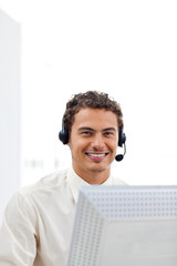 Smiling businessman working at a computer
