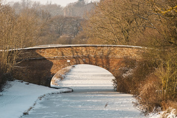 Bridge across a frozen canal in mid-winter