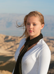 The young blonde in white blouse and black scarf