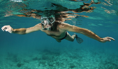man snorkeling underwater