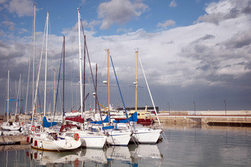 Fototapeta na wymiar Reflection of row boats in the harbor