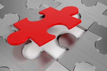 Brushed metal puzzle with the last piece falling into place