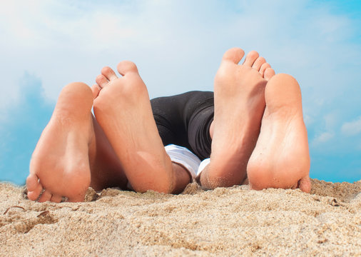 Couple Playing on the sand with feets