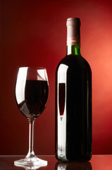 Glass and bottle of red wine.