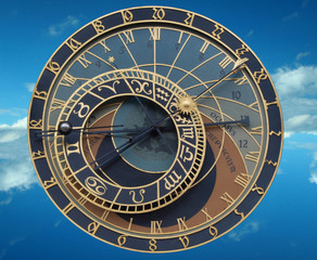 Old astronomical clock on sky background