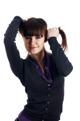The cheerful charming brunette female  in dark blue sweater