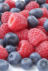 raspberries and blueberries on white