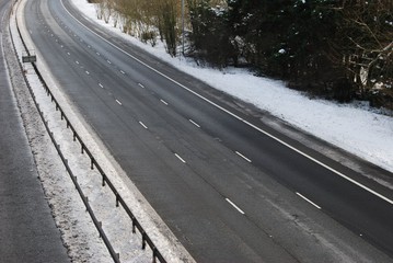 Empty three lane highway road in winter