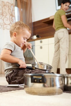 Little boy playing with cooking pots