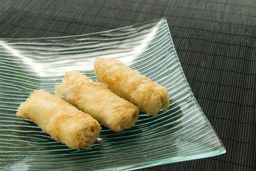 Three chicken egg rolls on a plate