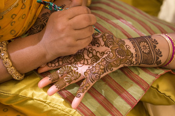 applying henna on hand, bride , traditional Hindu wedding , Rajasthan, India	