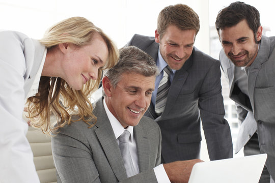 Business people looking at a computer screen
