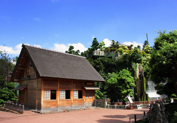 Fototapeta na wymiar a wooden hut with tree and blue sky