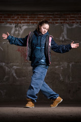 Hip hop dancer in modern style over brick wall