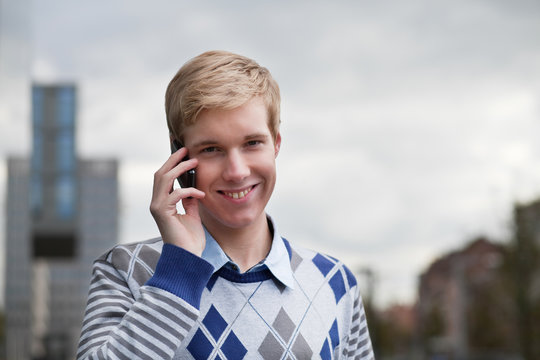 Young blond man with cellphone