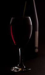 red wine with bottle in background
