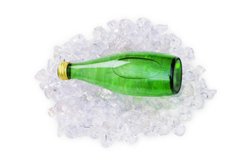 Green bottle of water on ice cubes
