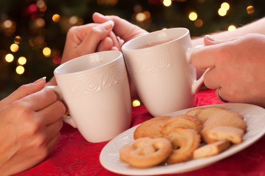 Man and Woman Sharing Hot Chocolate and Cookies