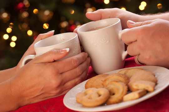 Man And Woman Sharing Hot Chocolate And Cookies