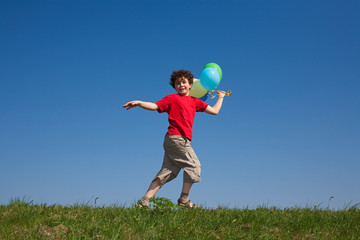 Kid holding balloons ,playing outdoor