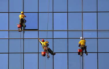 Men washing windows at height