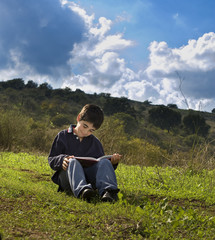 Naklejka na ściany i meble boy reading outdoor