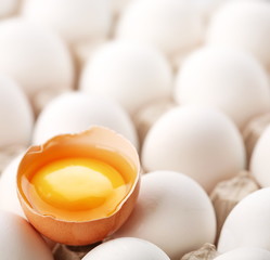broken brown egg is among the whites of eggs.
