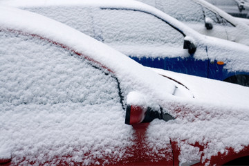 Row of snow covered cars
