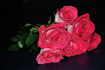 A bouquet or red roses on a black background