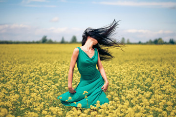 Happy beautiful woman in the field