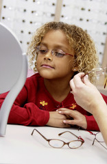 African American girl trying on glasses