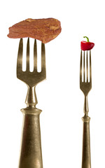 Two fork with bacon and pepper.