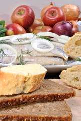 some fresh organic herring on a white plate