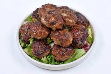 meat balls and with organic salad on a plate