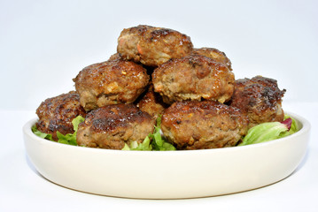 meat balls and with organic salad on a plate