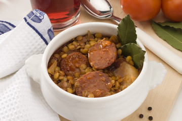 Spanish cuisine. Lentils with red sausage. Lentejas con chorizo.