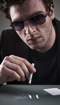 Young Man Sniffing Cocaine.