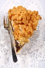Slice of pie on white lace tablecloth
