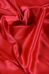 Red satin background with a heart shape
