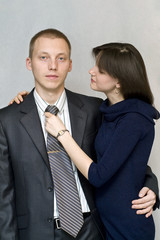 The girl straightens his tie man