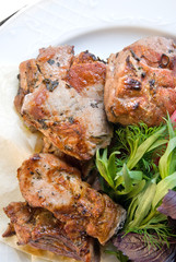 fried meat with potherbs on the plate