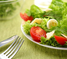 Fresh salad with tomato and quail eggs
