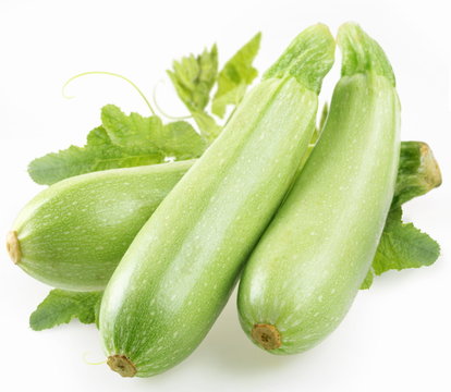 Ripe squash with leaves on white background