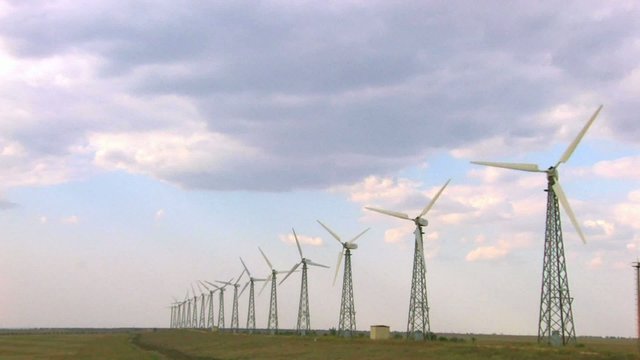 HD group of spinning wind turbines on the background