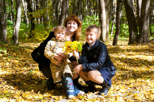 family in autumn leafs